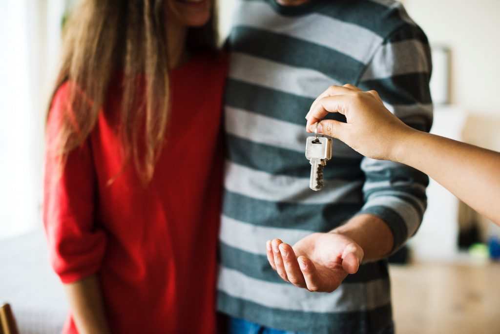 Couple receiving key for their new home.