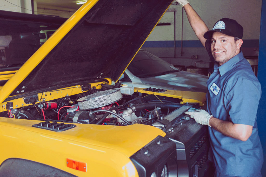 Mechanic working on a yellow car